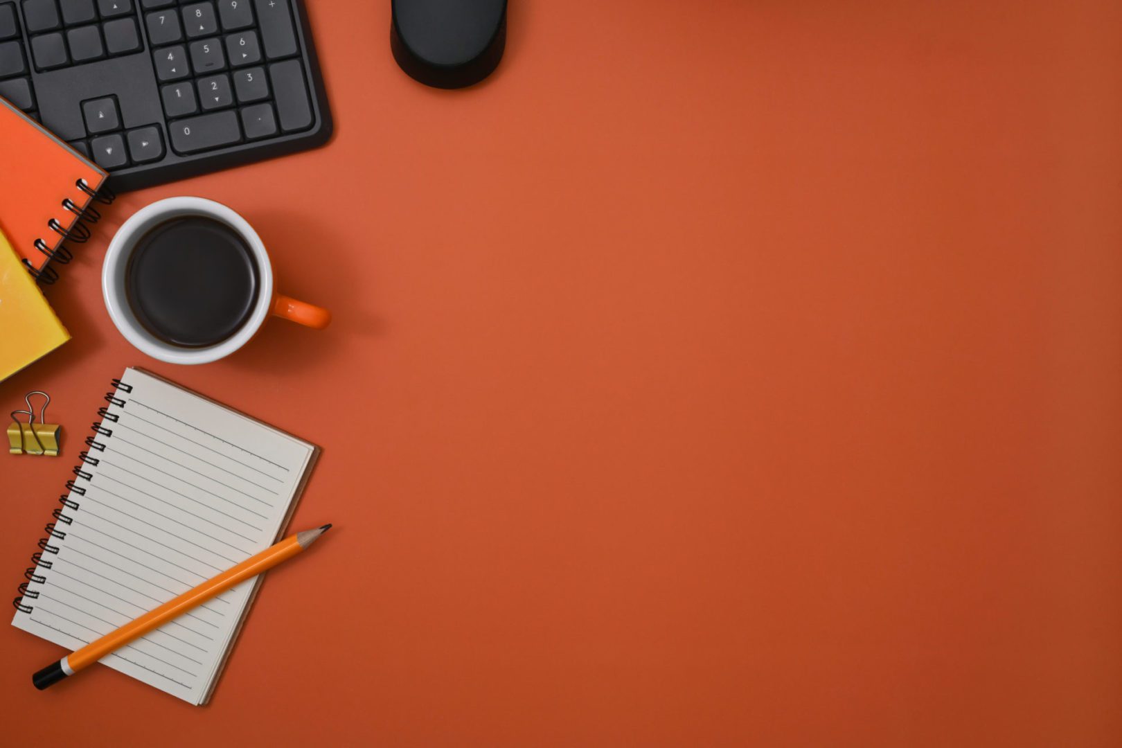 top view coffee cup notebook and keyboard on oran 2022 03 16 05 21 54 utc scaled